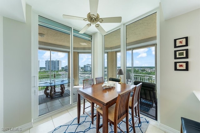 tiled dining area with ceiling fan and a healthy amount of sunlight