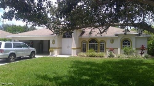 view of front of home featuring a garage and a front yard