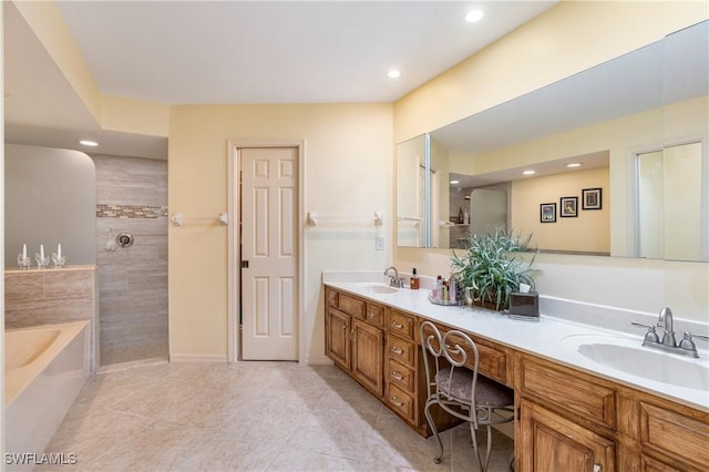 bathroom with walk in shower, double vanity, a bath, and a sink