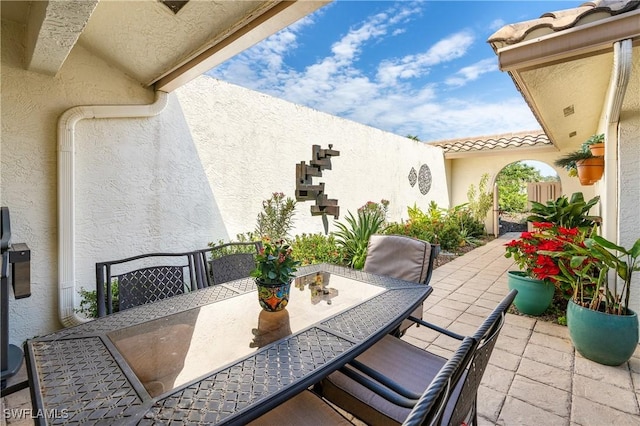 view of patio featuring outdoor dining space and fence