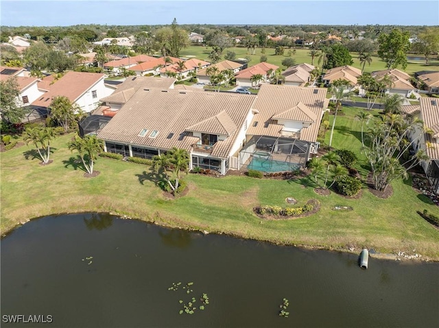 drone / aerial view with a residential view and a water view