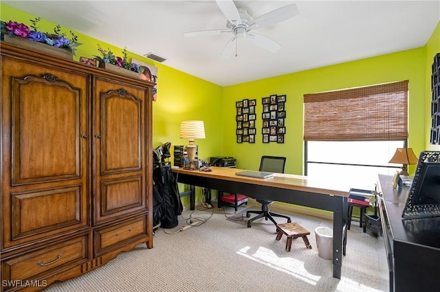 carpeted office space with visible vents and ceiling fan