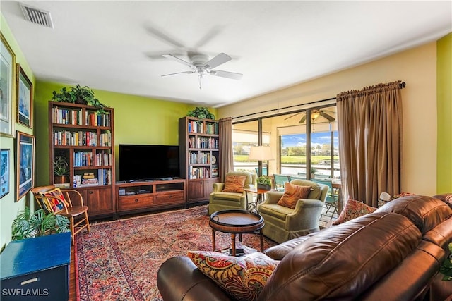 living room with visible vents and ceiling fan