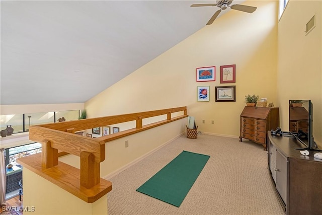 playroom featuring visible vents, light colored carpet, ceiling fan, and vaulted ceiling