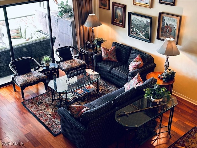 living room with baseboards and wood finished floors