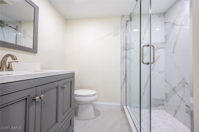 bathroom featuring vanity, toilet, and an enclosed shower