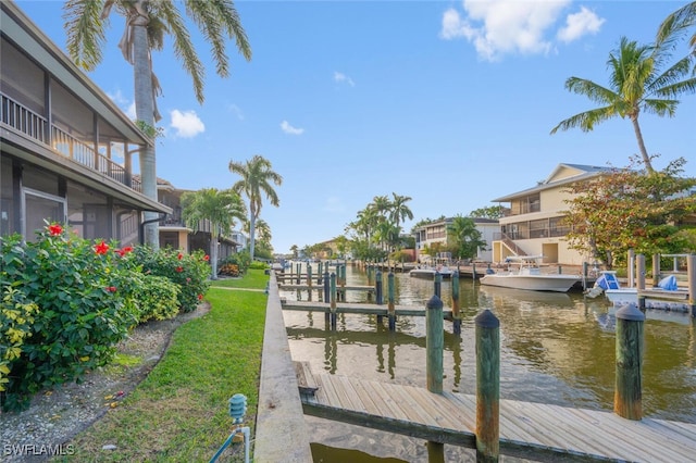 view of dock featuring a water view and a balcony