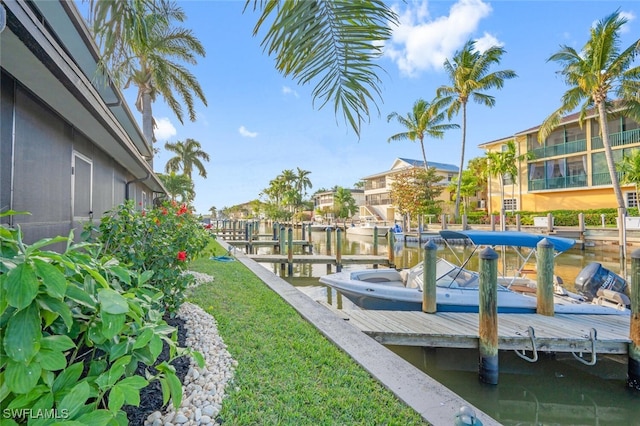 dock area with a water view and a yard