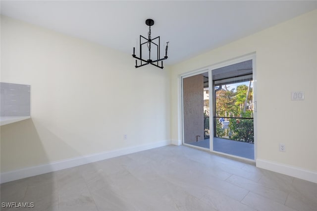 spare room with a chandelier