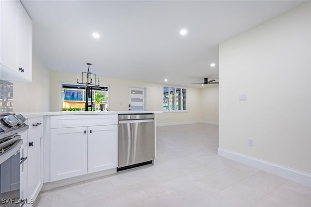 kitchen featuring ceiling fan with notable chandelier, white cabinets, stainless steel appliances, and pendant lighting