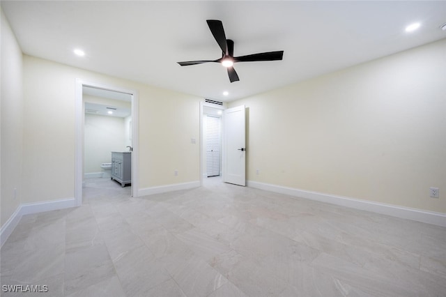 unfurnished bedroom featuring ceiling fan and ensuite bath