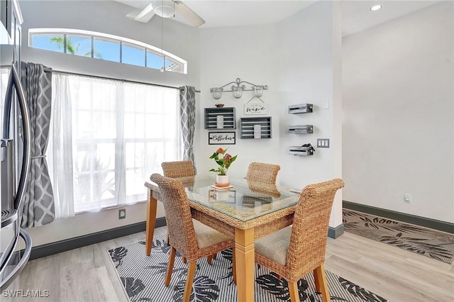 dining room with a wealth of natural light, ceiling fan, and hardwood / wood-style flooring