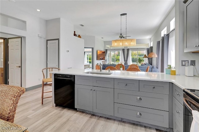 kitchen featuring gray cabinetry, ceiling fan, dishwasher, sink, and kitchen peninsula