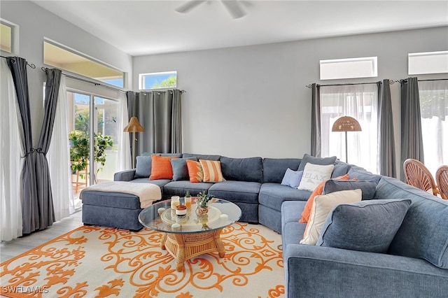 living room with ceiling fan, light hardwood / wood-style flooring, and a healthy amount of sunlight