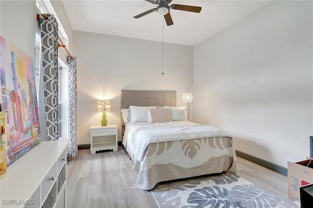 bedroom with ceiling fan and light hardwood / wood-style flooring