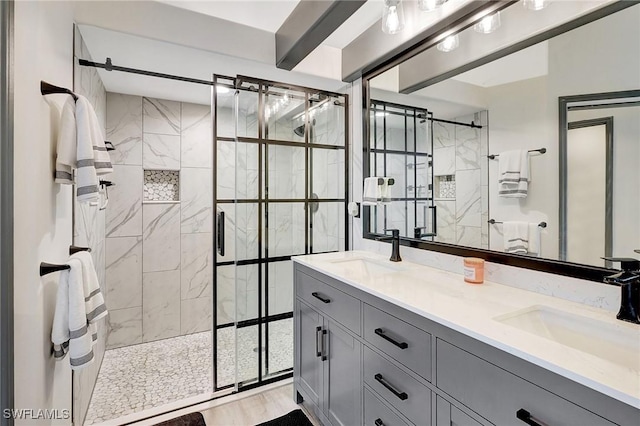 bathroom with hardwood / wood-style floors, vanity, and an enclosed shower