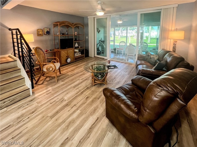 living room with light wood-type flooring and ceiling fan