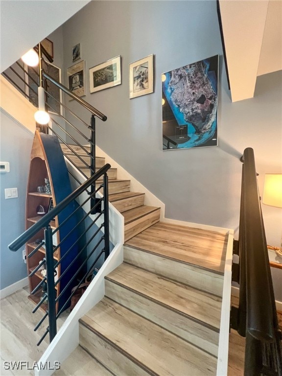 staircase with hardwood / wood-style floors