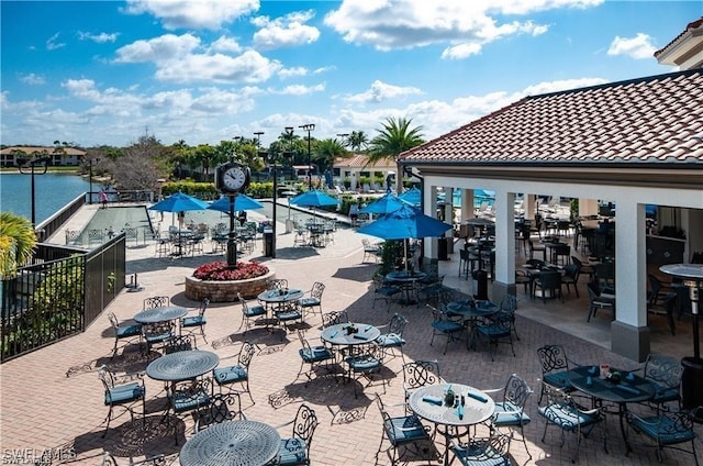 exterior space featuring a water view and a patio