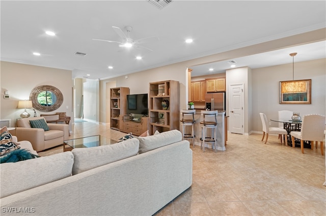 living room featuring ceiling fan, ornamental molding, and light tile patterned flooring