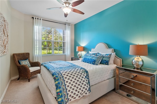 bedroom with ceiling fan and light colored carpet