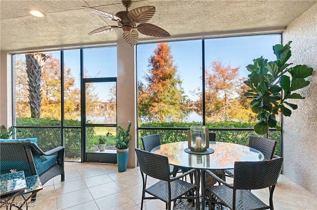 sunroom / solarium featuring ceiling fan