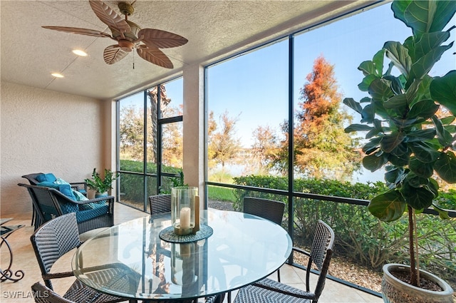 sunroom featuring ceiling fan