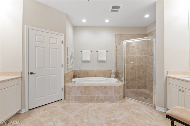 bathroom featuring vanity, independent shower and bath, and tile patterned floors