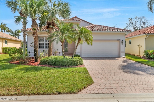 mediterranean / spanish house with a front lawn and a garage