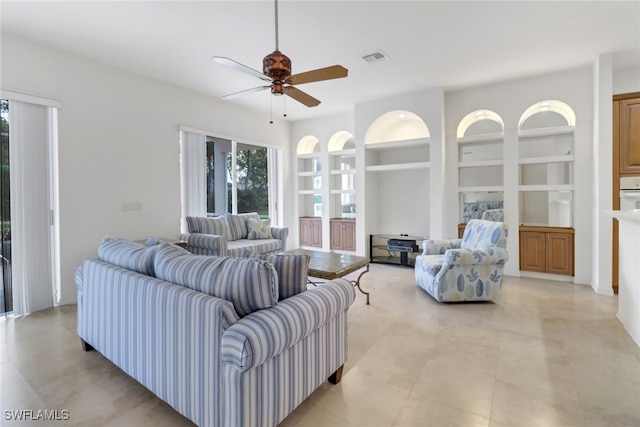 9246 Springview Loop, Estero, FL 33928 - living room featuring a ceiling fan, built in shelves, and light tile patterned floors