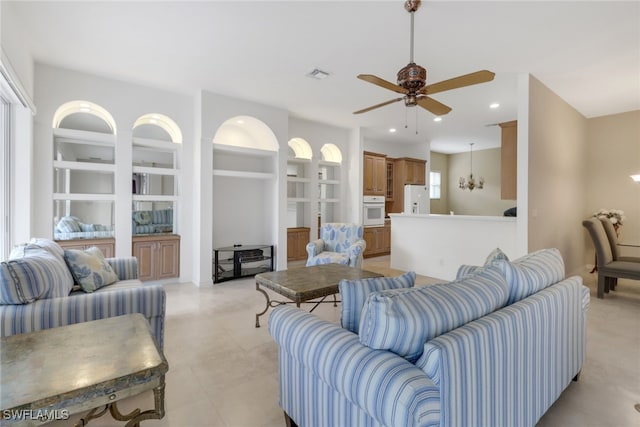 living room featuring ceiling fan with notable chandelier and a healthy amount of sunlight