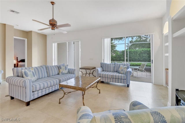 tiled living room with ceiling fan