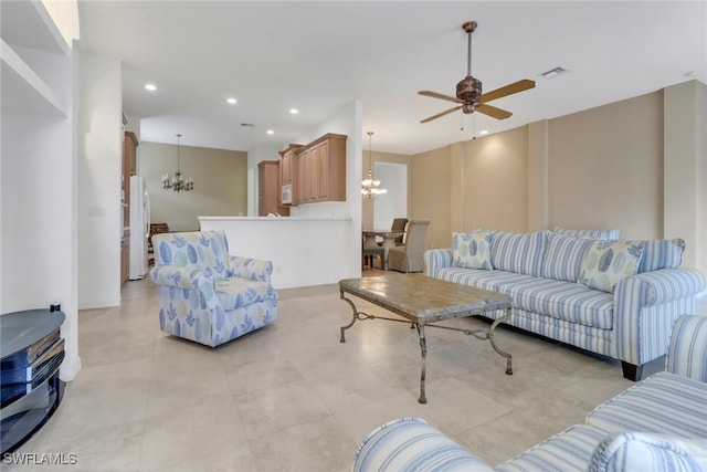 living room featuring ceiling fan with notable chandelier