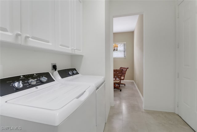 clothes washing area featuring light tile patterned flooring, cabinets, and separate washer and dryer