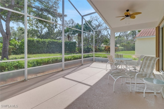 sunroom with a healthy amount of sunlight and ceiling fan