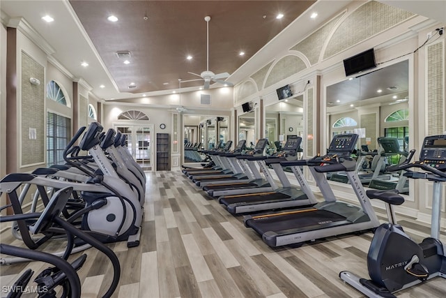 workout area featuring ornamental molding, a wealth of natural light, light wood-type flooring, and ceiling fan