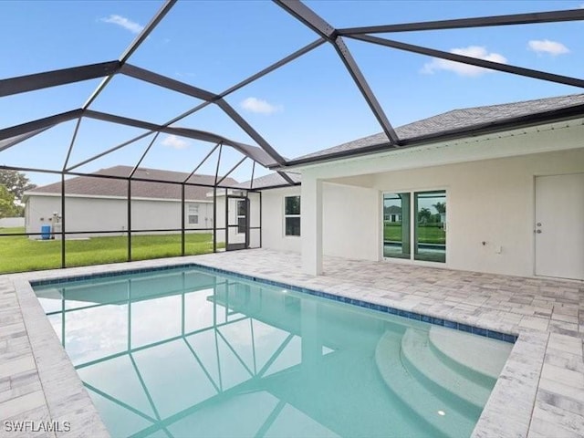 view of pool with a lanai, a yard, and a patio