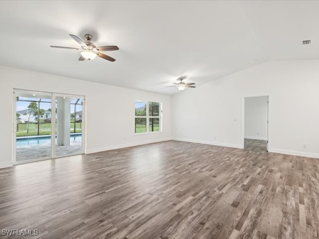 empty room featuring vaulted ceiling, ceiling fan, and hardwood / wood-style flooring