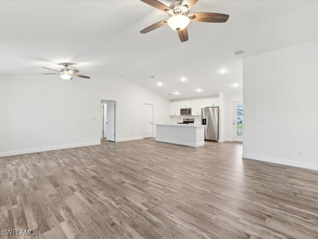 unfurnished living room with ceiling fan, light hardwood / wood-style flooring, and lofted ceiling