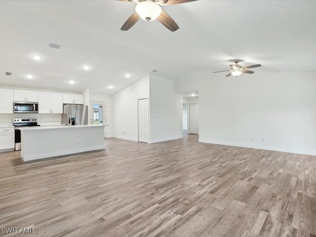 unfurnished living room with light hardwood / wood-style floors, lofted ceiling, and ceiling fan