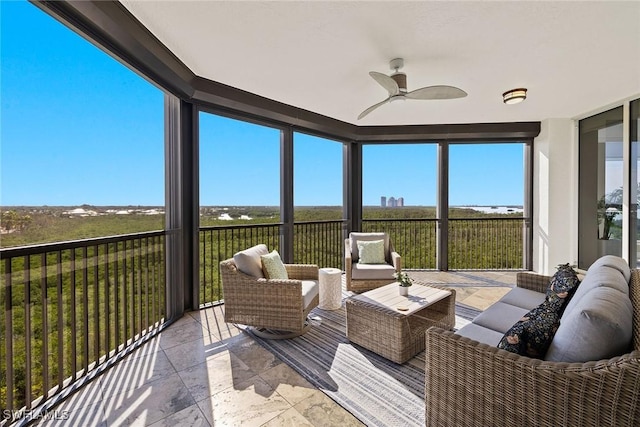 sunroom / solarium with ceiling fan and outdoor lounge area
