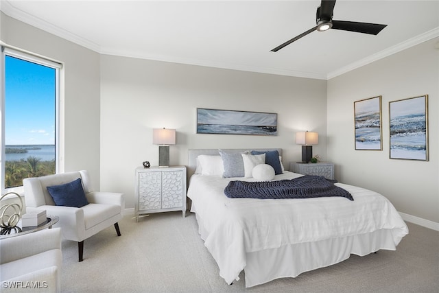 carpeted bedroom with ceiling fan and crown molding