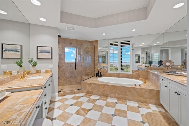 full bath featuring visible vents, a garden tub, recessed lighting, a sink, and a stall shower