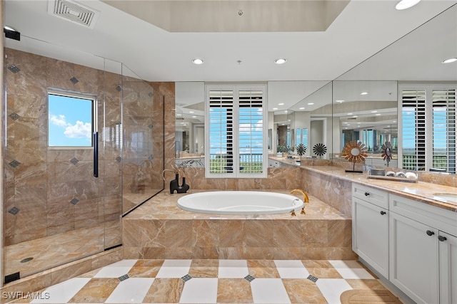 bathroom with vanity and separate shower and tub