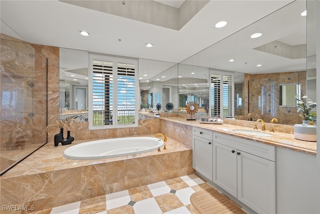 bathroom featuring vanity and shower with separate bathtub