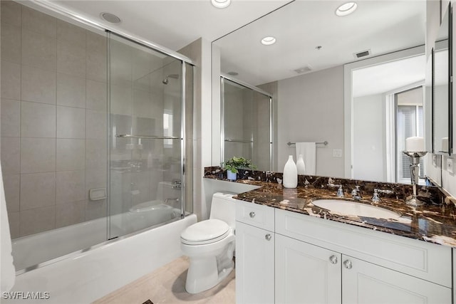 bathroom featuring visible vents, vanity, toilet, recessed lighting, and enclosed tub / shower combo