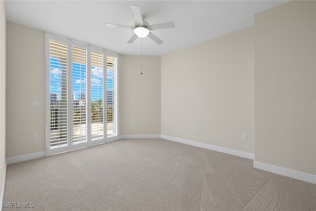 empty room featuring light carpet and ceiling fan