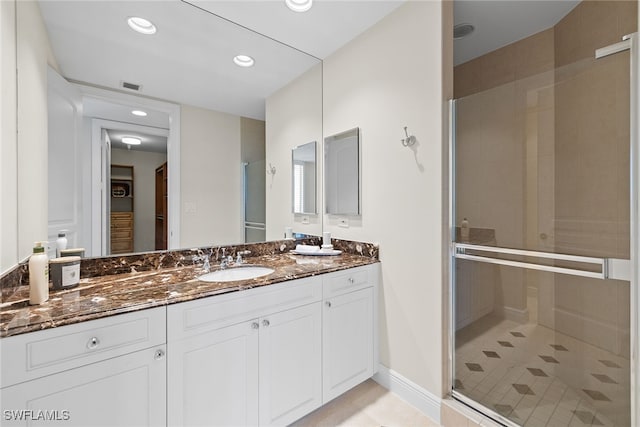 bathroom with vanity, tile patterned floors, and an enclosed shower