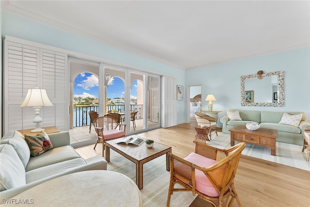 living room featuring ornamental molding, french doors, and light hardwood / wood-style floors