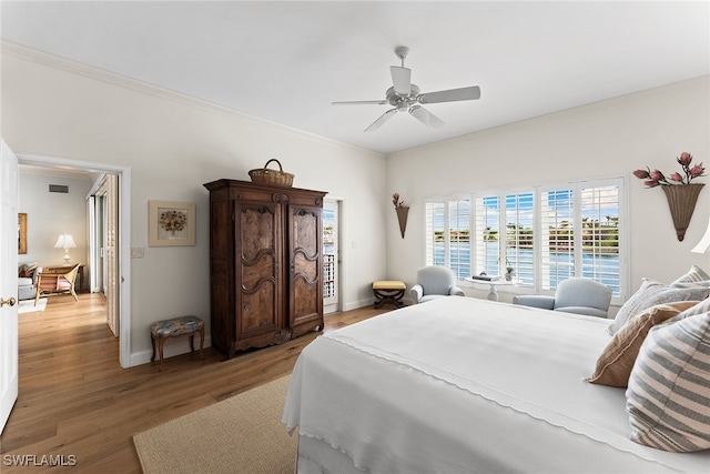 bedroom featuring ceiling fan, hardwood / wood-style flooring, and crown molding